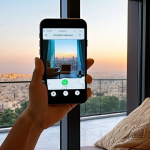 A person, visibly relaxed, engaging with a mental health AI app on their smartphone. The setting is a serene space, perhaps a modern living room with subtle Islamic geometric patterns in the decor or a quiet balcony overlooking a soft-lit, contemporary Arab cityscape. The AI interface on the phone screen emits a gentle, calming glow, symbolizing accessible 24/7 support. The overall mood is hopeful and private, emphasizing relief and easy access to mental wellness support from anywhere.